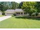 Charming single-story home featuring an attached garage, manicured lawn, and inviting front porch at 334 Bridgewood Se Dr, Conyers, GA 30094