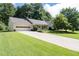 Inviting single-story home with well-maintained lawn and driveway leading to an attached garage at 334 Bridgewood Se Dr, Conyers, GA 30094