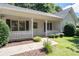Close-up of a charming front porch with decorative railings and manicured landscaping at 334 Bridgewood Se Dr, Conyers, GA 30094