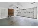 A garage with a brick accent wall, a garage door and a side entrance door at 334 Bridgewood Se Dr, Conyers, GA 30094