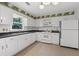 Well-lit kitchen featuring ample cabinetry, appliances, and tile flooring at 334 Bridgewood Se Dr, Conyers, GA 30094