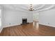 Spacious living room with hardwood floors, fireplace, and elegant tray ceiling at 334 Bridgewood Se Dr, Conyers, GA 30094