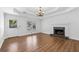 Open-concept living room with wood floors, fireplace, and access to the outdoors at 334 Bridgewood Se Dr, Conyers, GA 30094