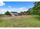 A full view of the home's large, grassy backyard and small storage shed at 5440 Huron Dr, Lake City, GA 30260