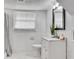 Bright bathroom featuring hexagon tiled floors, tiled walls, and a shower/tub combo at 5440 Huron Dr, Lake City, GA 30260
