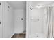 White tiled shower and laundry area in basement bathroom featuring a shower with curtain at 5440 Huron Dr, Lake City, GA 30260