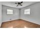 Empty bedroom with wood floors, white walls, and natural light at 5440 Huron Dr, Lake City, GA 30260