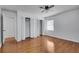 Comfortable bedroom with hardwood floors, ceiling fan, window, closet, and ensuite access at 5440 Huron Dr, Lake City, GA 30260