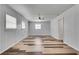 Spacious bedroom featuring wood paneled walls, ceiling fan, and stylish hardwood floors at 5440 Huron Dr, Lake City, GA 30260