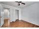 Bedroom with hardwood floors, ceiling fan, and a closet, as well as an ensuite bathroom at 5440 Huron Dr, Lake City, GA 30260