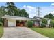 Charming home featuring a well-maintained lawn, a brick facade, and a convenient carport at 5440 Huron Dr, Lake City, GA 30260