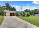 Charming home featuring a well-maintained lawn, a brick facade, and a convenient carport at 5440 Huron Dr, Lake City, GA 30260