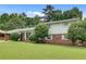 Charming home with a well-manicured lawn, complemented by a brick and siding exterior at 5440 Huron Dr, Lake City, GA 30260