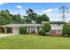 Charming home featuring a well-maintained lawn, a brick facade, and a convenient carport at 5440 Huron Dr, Lake City, GA 30260