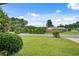 Spacious front yard with a lush green lawn and mature trees at 5440 Huron Dr, Lake City, GA 30260