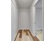 Hallway with wood paneled walls, base moulding and stylish hardwood floors at 5440 Huron Dr, Lake City, GA 30260