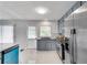 Updated kitchen features stainless steel appliances, gray cabinets, and white marble countertops at 5440 Huron Dr, Lake City, GA 30260