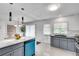 Bright kitchen features a peninsula island, stainless appliances, and gray cabinets at 5440 Huron Dr, Lake City, GA 30260