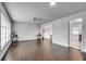Bright living room featuring hardwood floors, white walls, ceiling fan, and plenty of natural light at 5440 Huron Dr, Lake City, GA 30260