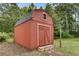 A charming red wooden shed with a window and double doors for extra storage at 5440 Huron Dr, Lake City, GA 30260