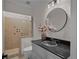 Bathroom featuring a shower and vanity with dark countertop, providing convenience and style at 8630 Moor Park Run, Duluth, GA 30097