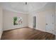 Spacious bedroom featuring a decorative tray ceiling, large window, and beautiful hardwood floors at 8630 Moor Park Run, Duluth, GA 30097