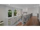Second floor hallway with hardwood floors, decorative wrought iron railing, and a view to below at 8630 Moor Park Run, Duluth, GA 30097