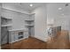 Upstairs hallway with custom shelves and views of stairs with iron railing at 8630 Moor Park Run, Duluth, GA 30097
