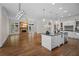 Open layout featuring the kitchen and a living room with stone fireplace at 8630 Moor Park Run, Duluth, GA 30097