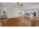 Open concept living space featuring hardwood floors and white trim, seamlessly connecting to a modern kitchen at 8630 Moor Park Run, Duluth, GA 30097