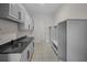 Mud room with sink, granite countertop, cabinets, and shelving at 8630 Moor Park Run, Duluth, GA 30097