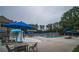Community pool and splashpad featuring many lounge chairs and tables with umbrellas, perfect for relaxation and Gathering fun at 8630 Moor Park Run, Duluth, GA 30097