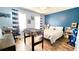 Bright bedroom featuring blue walls, striped curtains, and a foosball table for Gathering fun at 109 Red Fox Dr, Dallas, GA 30157