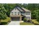 Charming two-story home with a stone-accented garage and manicured landscaping at 109 Red Fox Dr, Dallas, GA 30157