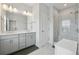 Elegant bathroom with double vanity, tiled floors, and a glass-enclosed shower at 3440 Hardy St, Duluth, GA 30096