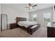 Spacious bedroom with large windows, ceiling fan, and a stylish wooden bed frame at 3440 Hardy St, Duluth, GA 30096