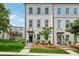 Charming three-story townhome with painted brick and manicured front yard at 3440 Hardy St, Duluth, GA 30096