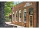 Niko's Wine Cellar & Bar boasts a charming brick facade with arched windows and vintage-inspired signage at 3440 Hardy St, Duluth, GA 30096