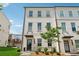 Charming three-story townhome with painted brick and manicured front yard at 3440 Hardy St, Duluth, GA 30096