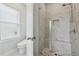 Modern bathroom with frameless glass shower, tiled walls and floor, and seat at 3440 Hardy St, Duluth, GA 30096