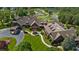 Aerial view of golf course and lake next to a clubhouse-like building at 4634 Whitestone Way, Suwanee, GA 30024