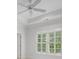 Bedroom with tray ceiling, fan, and shuttered windows at 4634 Whitestone Way, Suwanee, GA 30024