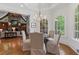 Cozy breakfast nook with elegant chairs and chandelier, adjacent to the open kitchen and living spaces at 4634 Whitestone Way, Suwanee, GA 30024
