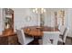 Dining room with a round table, chandelier lighting, and detailed wall trim at 4634 Whitestone Way, Suwanee, GA 30024