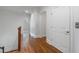 Well-lit hallway showcasing a door and elevator with hardwood flooring and crown molding details at 4634 Whitestone Way, Suwanee, GA 30024