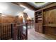 Hallway features wood paneling, wood floors, wrought iron railings, and custom built-in shelving at 4634 Whitestone Way, Suwanee, GA 30024