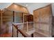 Second-floor hallway with wood paneling, built-in bookshelves, and access to multiple rooms at 4634 Whitestone Way, Suwanee, GA 30024