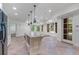 Open concept kitchen with tile flooring and a large center island at 4634 Whitestone Way, Suwanee, GA 30024