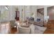 Spacious living room with hardwood floors, neutral furniture, and large arched windows filling the space with light at 4634 Whitestone Way, Suwanee, GA 30024