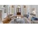 Bright living room with hardwood floors, neutral furniture, a decorative rug, and natural light at 4634 Whitestone Way, Suwanee, GA 30024